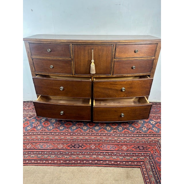 This Stately Lowboy Dresser with Lock offers a graceful blend of presence and practicality. Its gently bowed drawer fronts...