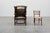 A refined British mid‑century wing back armchair, upholstered in deep olive‑green leather with a beautifully aged patina....