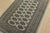 A tribal Bokhara rug hand-knotted with fine wool on a cotton foundation. This rug features rows of repeating medallions...