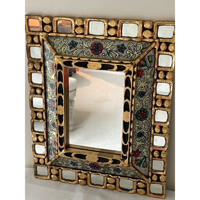 This mirror is a show stopper! It has everything you need to make an impact in a room... color, sparkle, geometry, and...