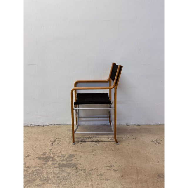 Folding director’s chair with bentwood and steel frame with black canvas seat and back rest by Federico Giner.