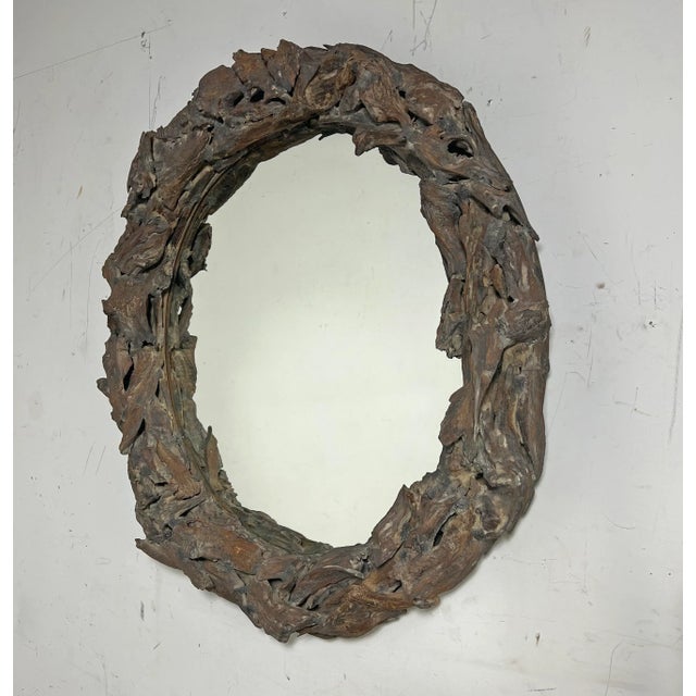 A rustic rondelle wall mirror in driftwood, circa late 20th century.
