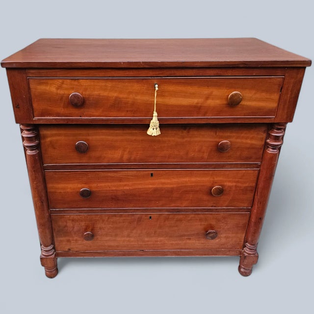 This 19th Century Chest of Drawers is made of solid wood that has acquired a deep patina over time. The facade of this...