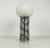 Extraordinary table lamp made in Italy in the 1960s. It is fascinating with its opal glass stuck on the chrome body....