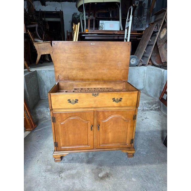 Vintage Chippendale style wooden flip-top bar cabinet or liquor server dry bar. It features a solid maple wood, flip top...