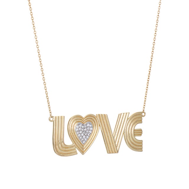 Distinct & beautifully detailed the contemporary 'Love' necklace is crafted in 14 karat yellow gold. Diamonds total an...