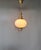 A sophisticated vintage pendant lamp featuring a beautifully proportioned white opal glass globe suspended within an...
