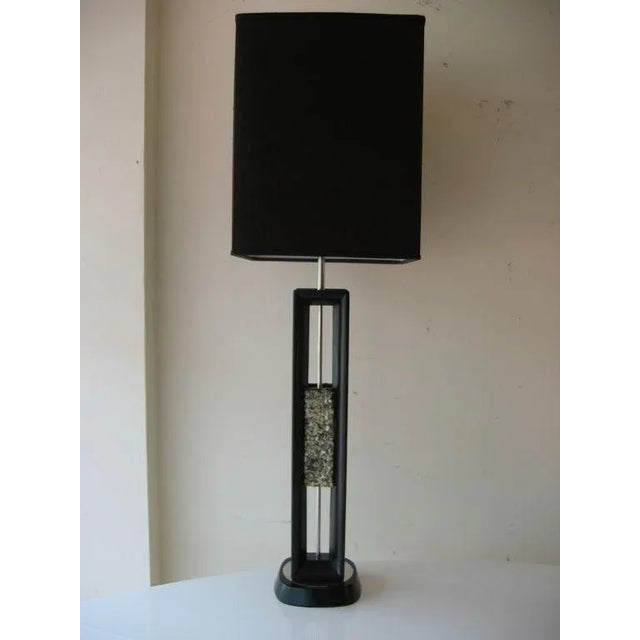 This vintage tall Danish ebonized wood mid century modern table and or desk lamp has a center grouping of stones and...