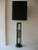 This vintage tall Danish ebonized wood mid century modern table and or desk lamp has a center grouping of stones and...