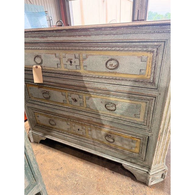 Light blue hand painted dresser with wood engravings and metal details.