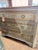 Light blue hand painted dresser with wood engravings and metal details.