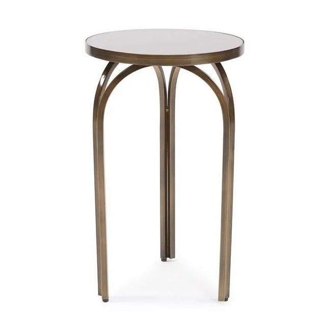 The arched windows of the early 18th century inspired the design of the Tea Tint Side Table.The hand rubbed bronze finish...