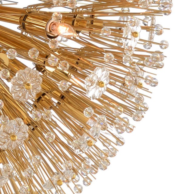 1930's hollywood regency chandelier, sparkling crystal flowers & faceted beads burst from the center orb. Polished brass...