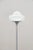 Iconic rare-form Italian floor lamp designed for Guzzini in the 1960s. Round chromed metal base with cast iron...