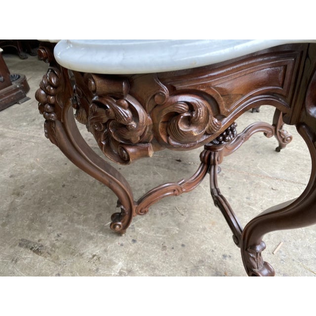 J. H, Belter rosewood carved fruit and nut marble top table. It measures 30” tall by 46.5” by 30”. Please note that...