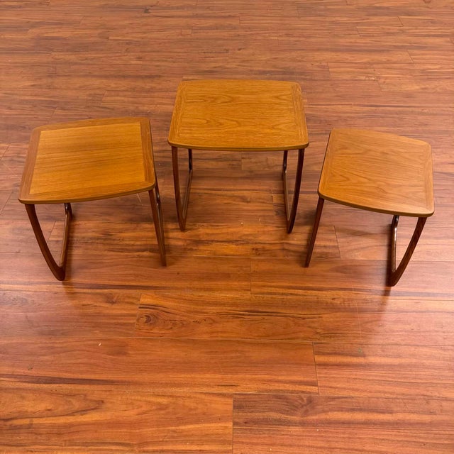 Vintage mid-century set of three teak nesting tables, made in the U.K. by Nathan Furniture circa 1970's. They feature...