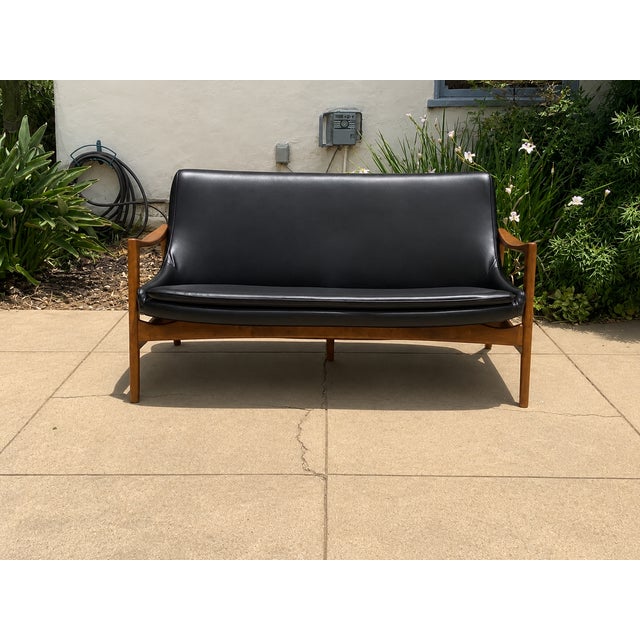Mid-century-style sofa. The sofa was made in the style of Ib Kofod-Larsen. The sofa is stained a light walnut, matte...