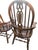 An exceptional, heavy-duty set of six (6) traditional bow-back Windsor dining chairs crafted from substantial solid golden...