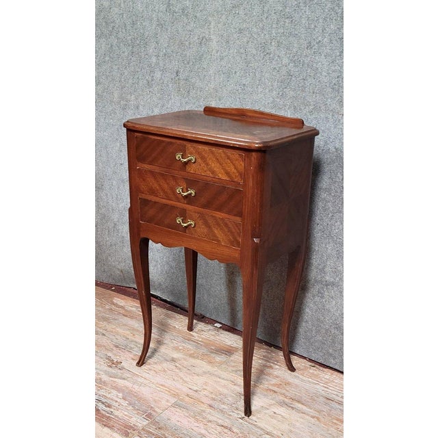 Louis xv style mahogany bedside table, circa 1900. Three drawers open at the front. Wooden top. Rests on four cabriole...