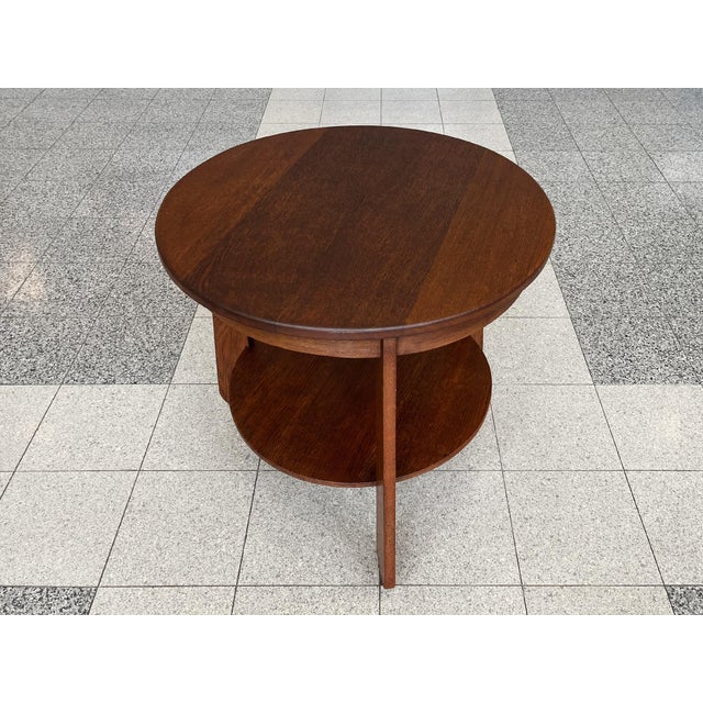 Originally hand-crafted in the Netherlands in the 1920s, this round Art Deco side table is white oak with a rich warm red-...