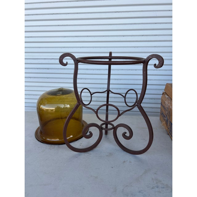 Handmade Brown wrought Iron stand measuring 15” x 17.5” tall. Includes a large air blown glass . The glass bowl that sits...