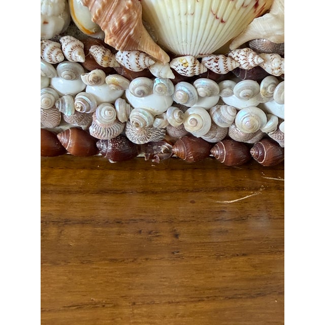 A spectacular pair of handcrafted vintage seashell-encrusted obelisk-form candleholders, constructed of substantial...