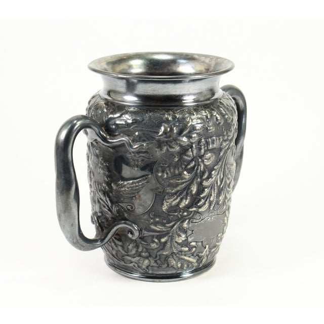 A stunning silvered trophy urn or vase Lavish embossed decoration, executed in great detail, featuring flying Fenix birds...