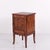 Bedside table crafted in dark wood with brass mounts and elegant tapered legs. Dating from the 1940s, it offers practical...