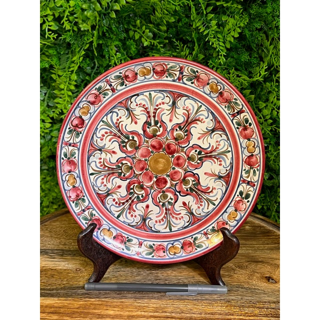 This is a beautiful vintage hand-painted ceramic plate from Germany. The plate has a unique pink floral design. The artist...