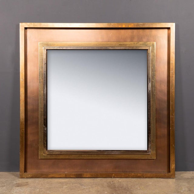 A vintage 20th century large statement mirror from belgo chrome. A deep bronzed square, framing a smoked glass mirror...