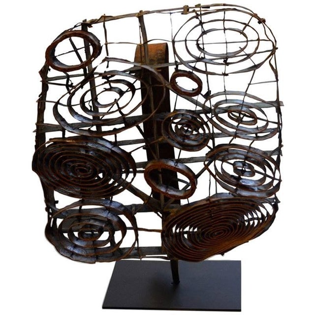 Beautiful antique copper batik stamp set on a modern black stand.