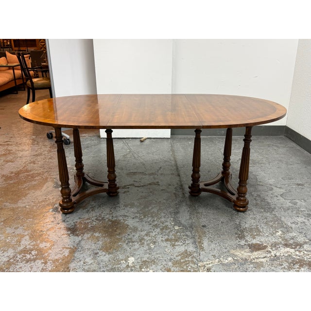 Design Plus Gallery presents the Gateleg Dining Table from Heritage. This traditional table has an oval wood top with...