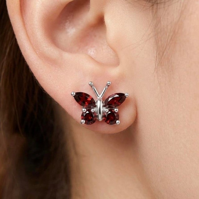 Graceful and captivating, these butterfly earrings beautifully blend nature-inspired design with the rich allure of deep...