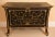 A contemporary large and exquisitely painted black with gold trim two-drawer custom chest with a carved greek key motif....