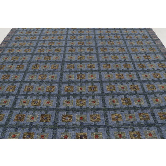 This 9x12 Scandinavian geometric kilim, handwoven in wool and natural yarns, features a rhythmic grid of floral-inspired...