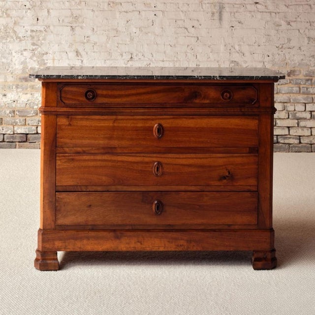 Elevate your space with this 19th century French walnut chest of drawers with marble top, a timeless antique that combines...