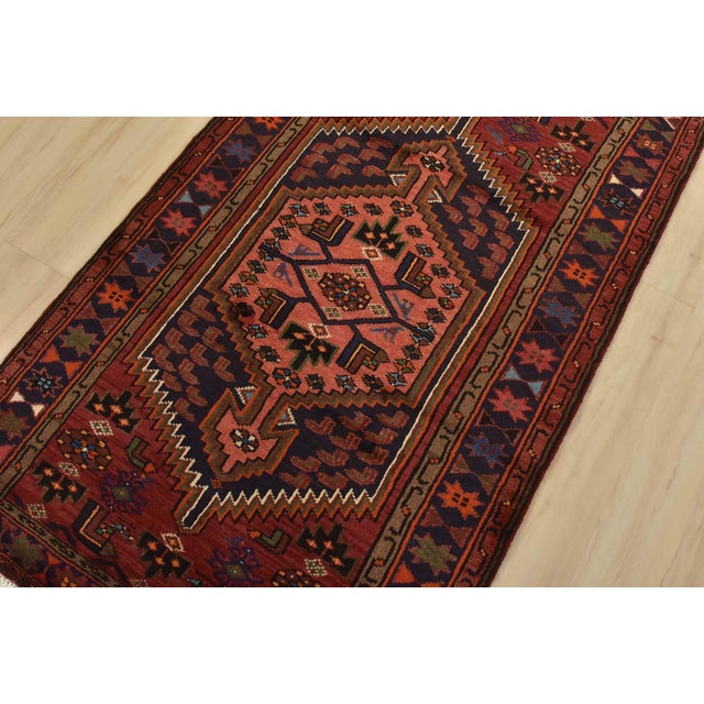 An authentic vintage tribal Hamedan rug hand-knotted with fine wool and natural dyes. This nomadic rug features a central...