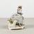 This delicate porcelain figurine, branded capodimonte, depicts a lady seated in a graceful and contemplative attitude. She...