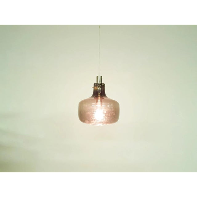 About this item Grey glass light with metal tube for lamp socket This piece is attributed to the mentioned designer/maker....