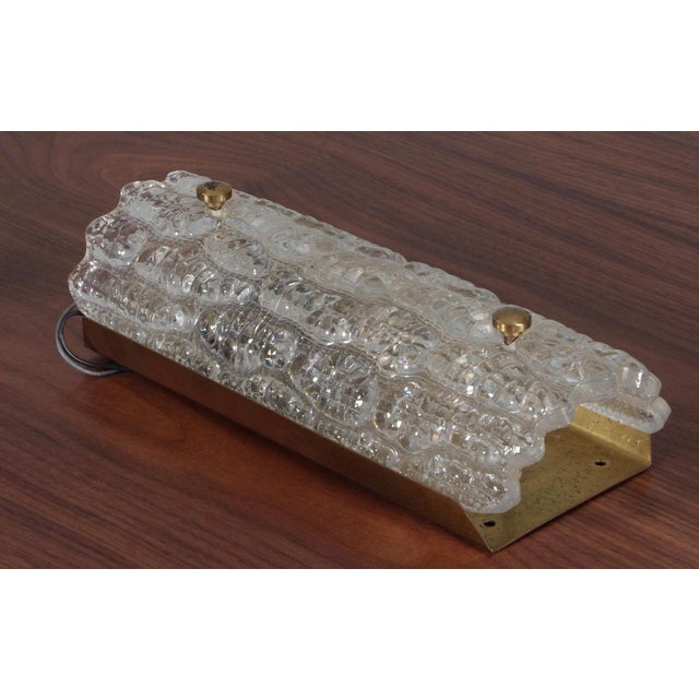 Carl Fagerlund wall lamp in glass and brass. Made by Lyfa/Orrefors. This piece is attributed to the mentioned...