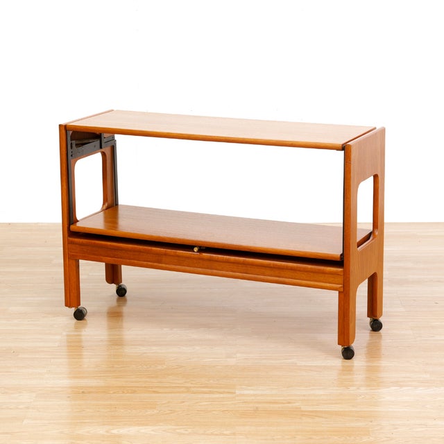 This fantastic mid century bar cart was manufactured in England during the early 1960s. Sitting on four castors it can be...