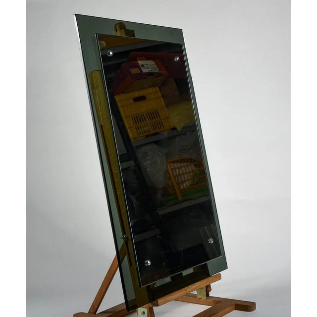 Burnished glass mirror on a smoked glass frame with chrome hooks, design italy 1970 measurements cm 58 x 3 x h 78.5...