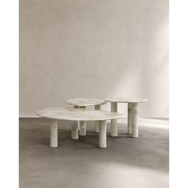 Set of 3 sunpoet coffee tables in carved honed bianco onyx by paloma editions dimensions: large: d 77 x w 111 x h 35 cm....