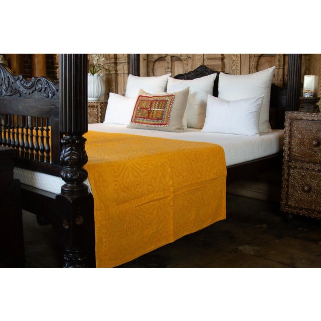 A lightweight cotton coverlet from Western India, beautifully adorned with decorative handcrafted applique cut work using...