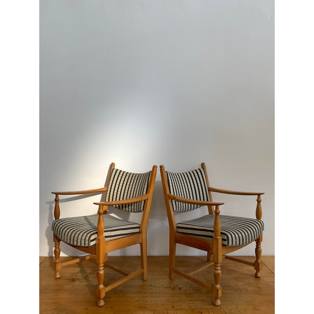 Elevate your living space with this sophisticated pair of vintage Scandinavian lounge chairs. Crafted from solid oak,...