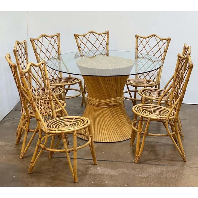 A fine French rattan round table or center table, featuring a large circular glass top over a stylish design pf spiral...