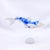 This artwork features a stylized fish rendered in a glossy white resin cast, adorned with intricate blue and gold patterns...