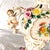 This is, for lack of a better word, a footed bowl with two angels on either handle and a lot of three dimensional flowers....
