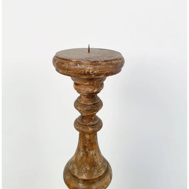 A single rustic carved wood pricket, circa 1800.