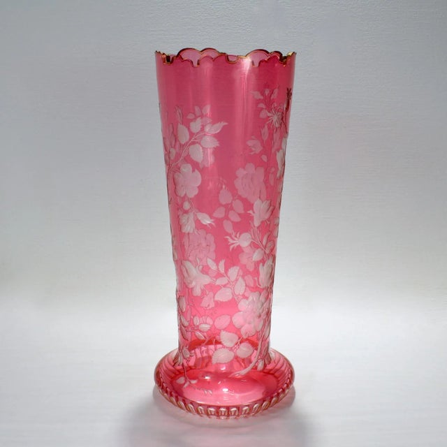 A fine antique Bohemian glass vase. With a cranberry overlay cut to clear glass. Wheel engraved with various species of...